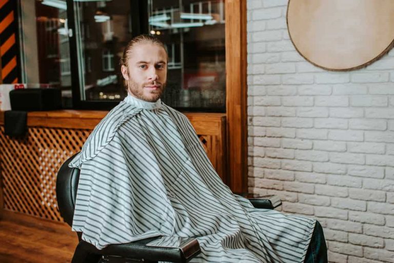 Man wearing a cool barber cape